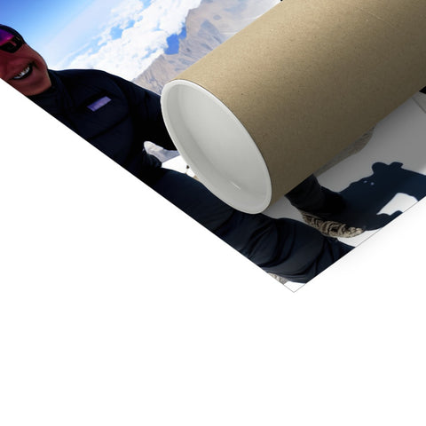A white, rectangular roll of toilet trash off of a roll, rolling in the palm