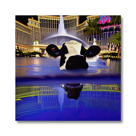 A cow, standing near some water near the fountain of the Lake in Las Vegas.