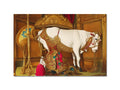 A place mat on a table with decorative decoration and a cow standing on it.