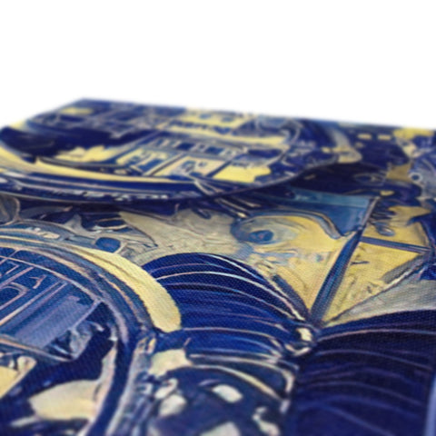 A trays of silver and blue and gold foil on a table table.
