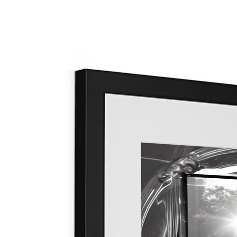 a black and white picture frame in a metal box hanging on a mirror
