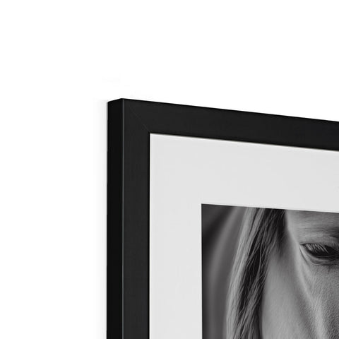 A picture frame with a black and white photo on it next to pictures of people on