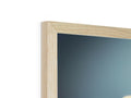 A picture frame sitting on top of top of a wood wall with a picture cut out