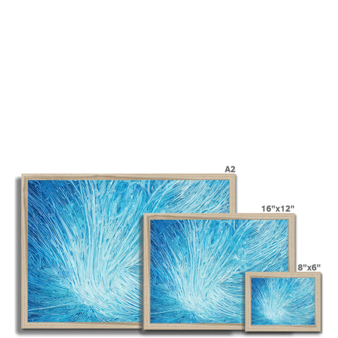 A large picture frame filled with various white and blue framed paintings sitting on a wall.