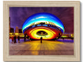 Large round picture framed in metal with a framed image of a building with a roof and