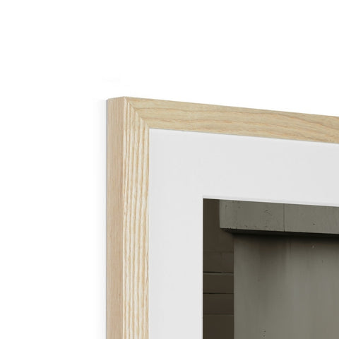 a picture frame with a wooden counter made of wood in a white room.