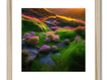 Art print in a colorful frame sitting on top of a hill next to a grassy