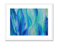 An art print depicting colorful waves in the ocean sitting next to a white bench