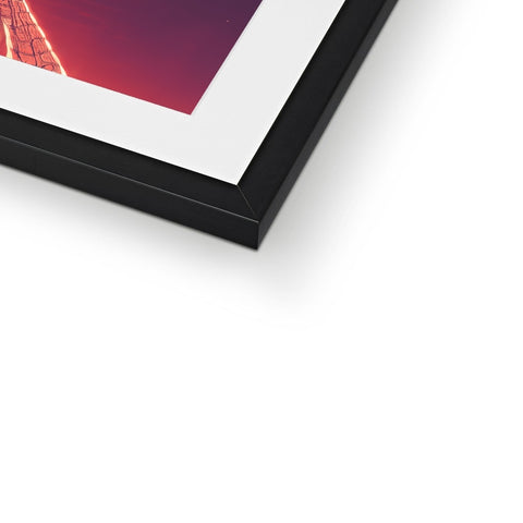There is a picture sitting on top of a photo frame with black frames.