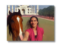 A woman is standing next to a horse in a picture.