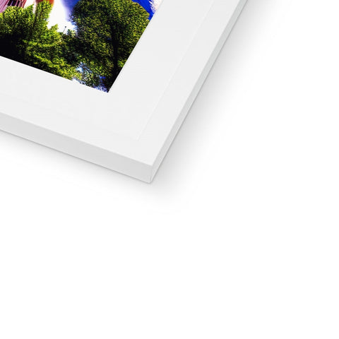 A white photo frame that has a blue backdrop, a white photo and two white photographs