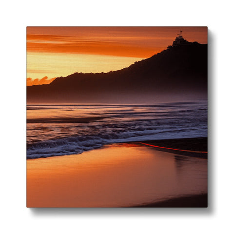A silver art print of a colorful beach with a sunset on it.