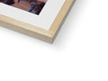 A wooden picture is placed in a white photo frame with a picture at the bottom of