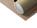A roll of tissue is placed on top of a table with a brown paper roll.