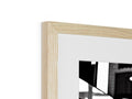 a picture frame hanging on a wall with a black and white wooden frame