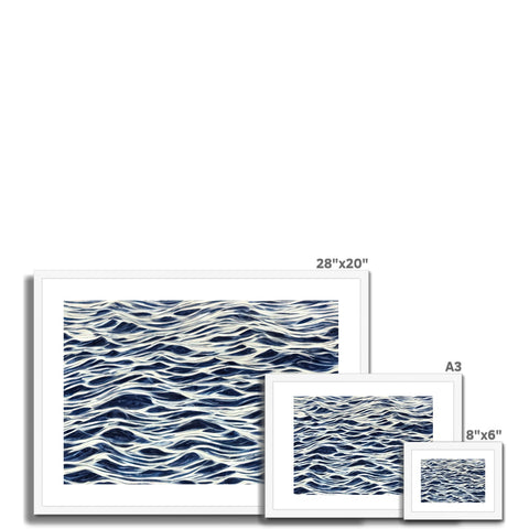 A picture of sea waves in a picture frame laying on a tile floor with art printed