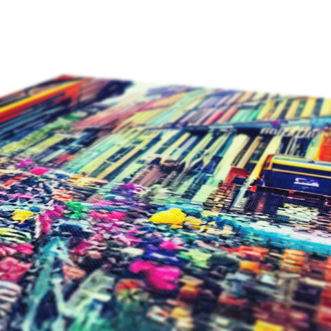 A pile of magazines on a table covered with colorful paper