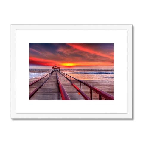 A framed photograph of a beautiful sunset perched on a pier with a beautiful ocean view.