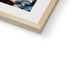 A photograph of a book hanging on a piece of wood is placed in a picture frame