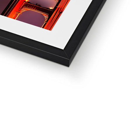 A photo frame of a white frame sitting in a frame with a red photo next to