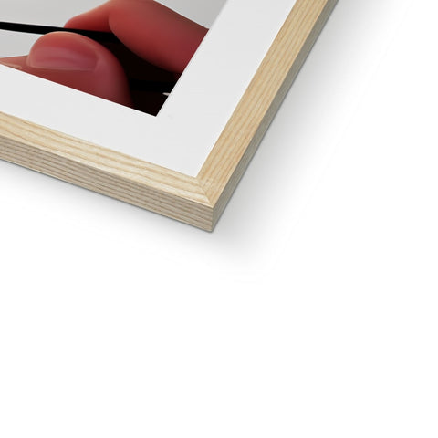 A very close-up of the picture holding on a white framed picture on a wooden