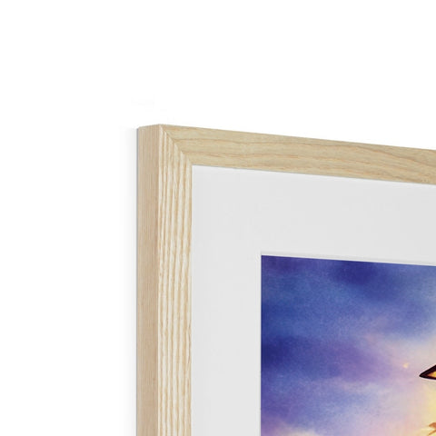 a picture of a bird standing on top of a picture frame sitting next to a wooden