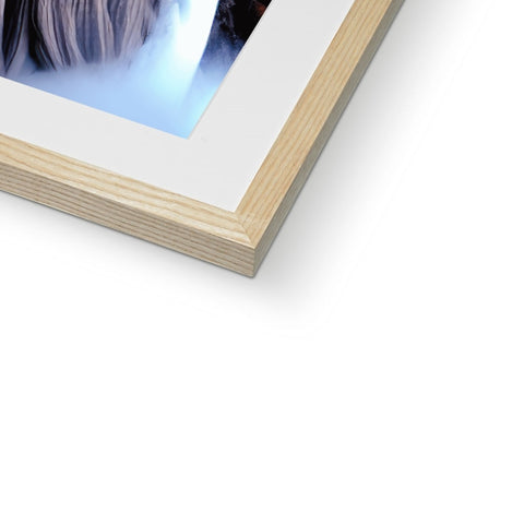 A photograph of the white background of an image in frame on a wooden picture frame