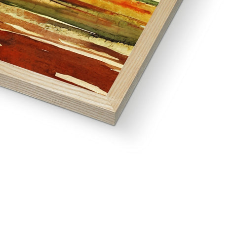 An abstract painting with a wood frame on top of a table area with a photo on