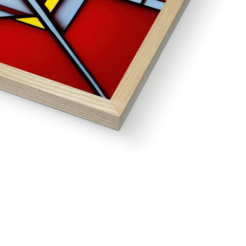 A stained glass picture of a cross in an art frame on a table.