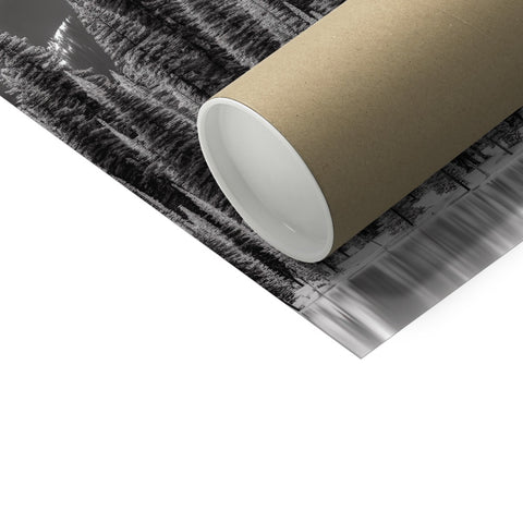 A metal tube of wrapping on a white table in a room.