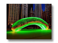 A fountain that is illuminated with lights in a green water.