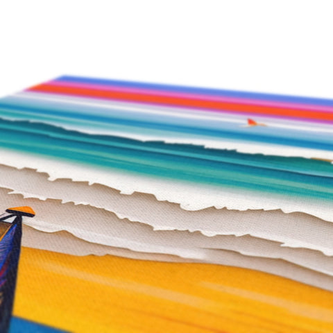 A table with a table with many colorful colors of paper towels and a blue blanket.