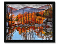A wall hanging of a picture with foliage on it of mountains in autumn.