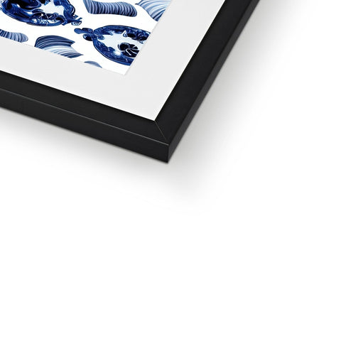 A framed photo of a white art print in a box on a wall.