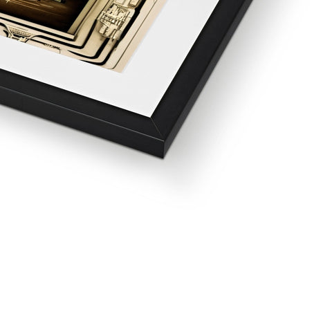 A framed picture on a black and white photograph frame with gold trim and gold and silver