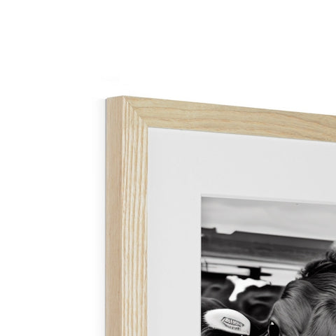 a picture of a black and white photo sitting on a picture frame with a wooden frame