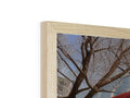 A photo frame with a picture of a man standing and talking next to a tree.