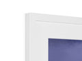 A picture frame is on a white background with a blue door framed on it.
