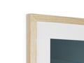 A picture frame with glass and wooden panels next to it sitting on a wall.