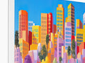 Several colorful framed art prints on a painting of San Francisco's skyline.