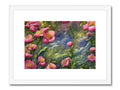 An art print with flowers next to a streambed and water.