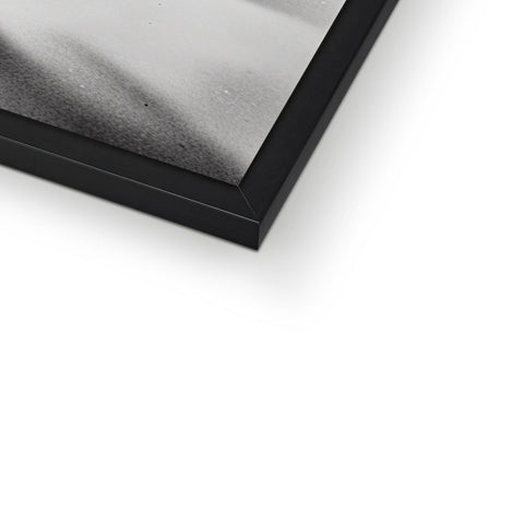 Photographic frame on silver and black foil on a wall holding a photo.