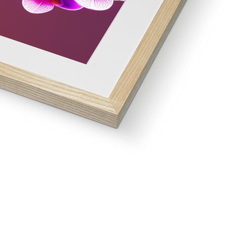 An art print of a purple flower in a picture frame.