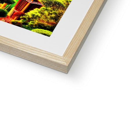 A picture frame in a white wood framed book on a green background.