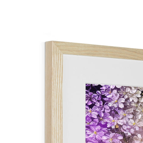 A white framed picture in one of two pieces of wood with flowers for a frame,