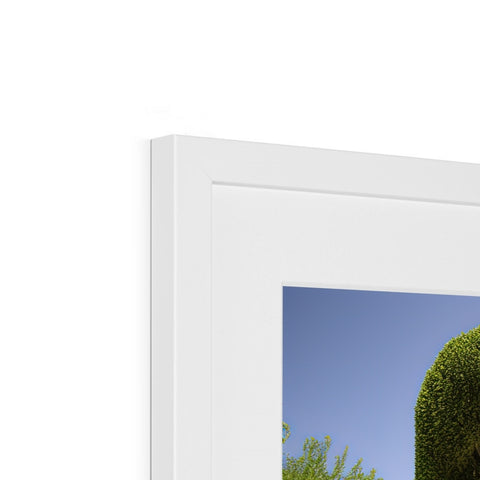 A display of a white picture frame on top of a window.