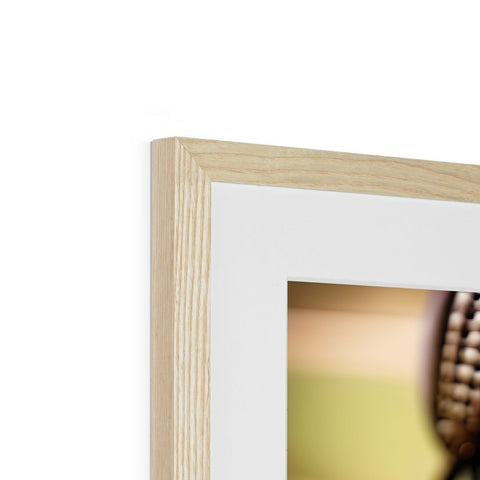 A photograph is in a wooden frame on a piece of plastic with some pieces of wood