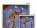 Several giraffes standing around a large picture frame with a giraffe standing next to