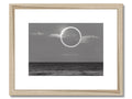 An art print that contains a photograph of a moon with clouds and a blue sky.