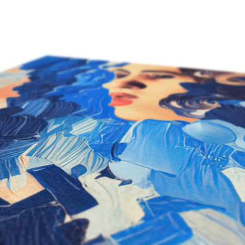 A table topped with art prints printed on blue paper.